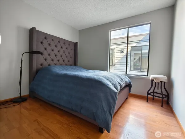 a bedroom with a bed chair and a window