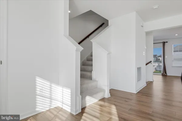 a view of a hallway view with wooden floor and staircase