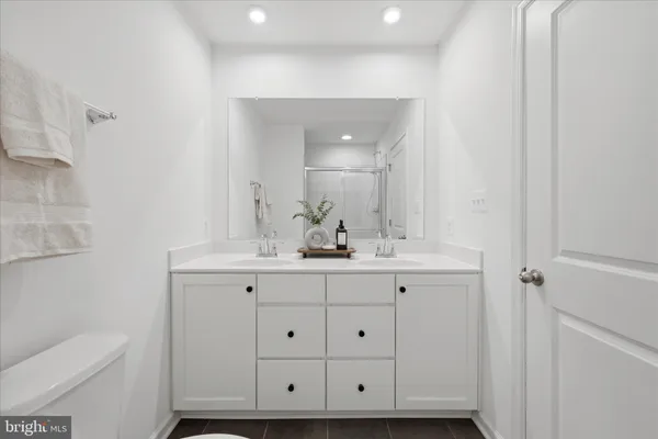 a bathroom with a sink toilet vanity and tub