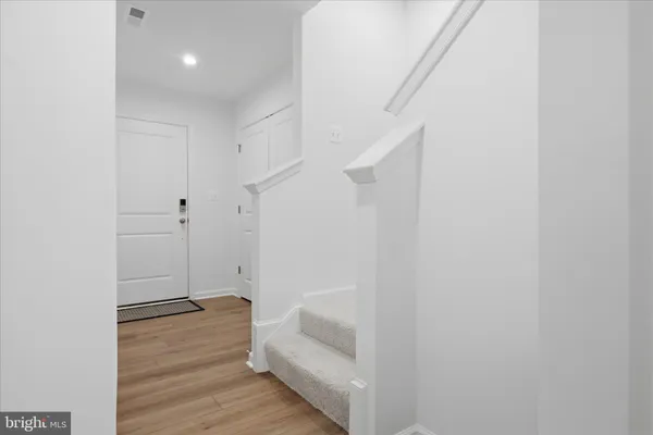 a view of room with wooden floor