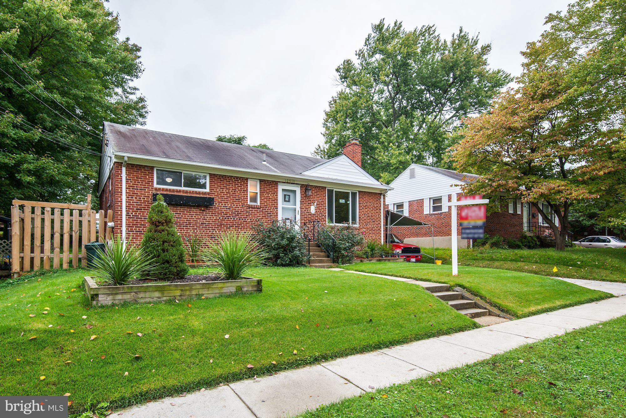 12510 Goodhill Road Silver Spring, MD 20906 - Photo 2 of 28 a front view of a house with a yard and trees
