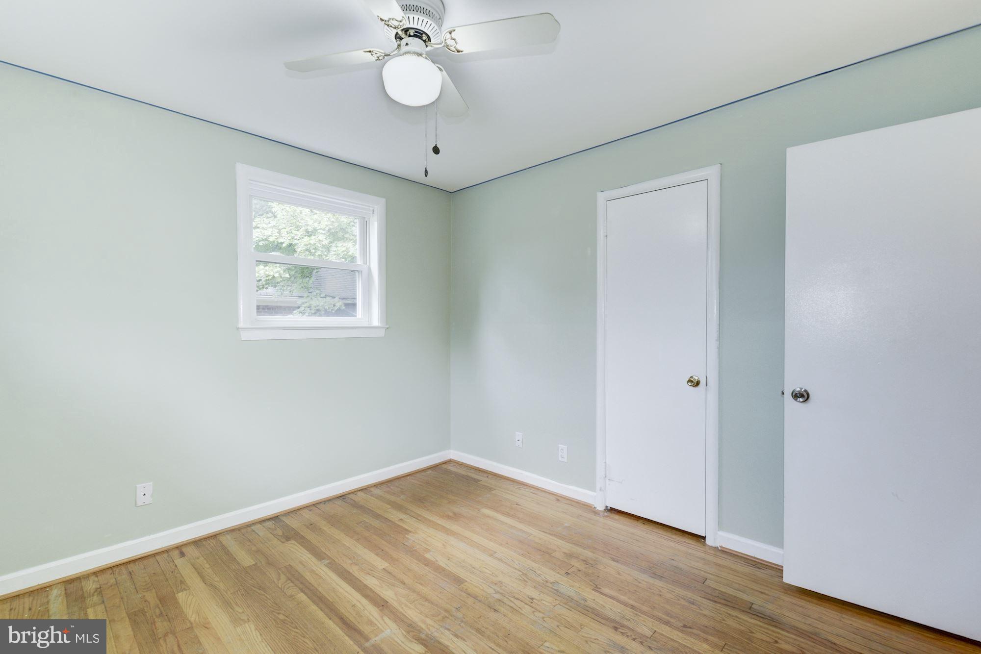 12510 Goodhill Road Silver Spring, MD 20906 - Photo 13 of 28 an empty room with wooden floor and windows