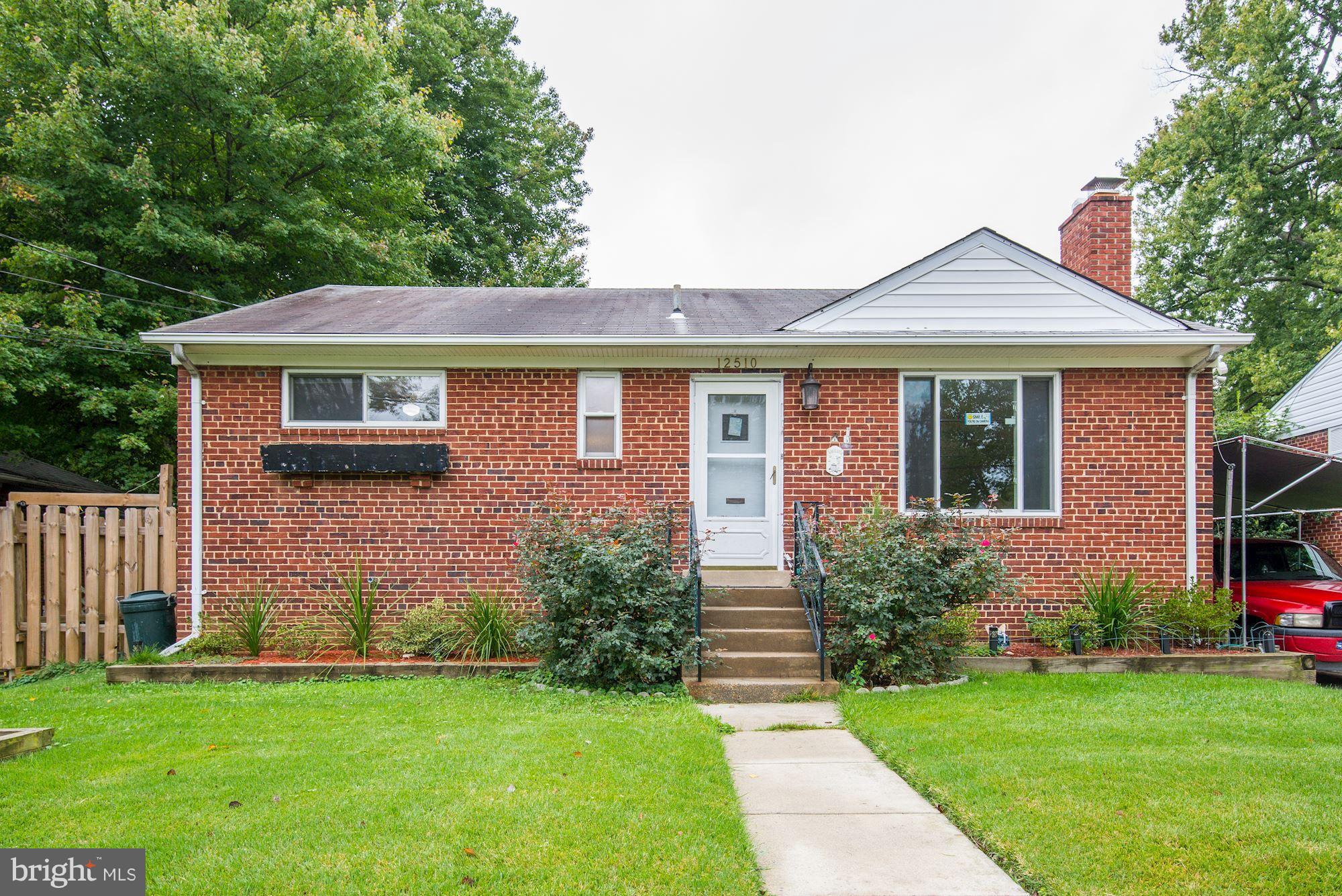 12510 Goodhill Road Silver Spring, MD 20906 - Photo 3 of 28 a front view of a house with a garden