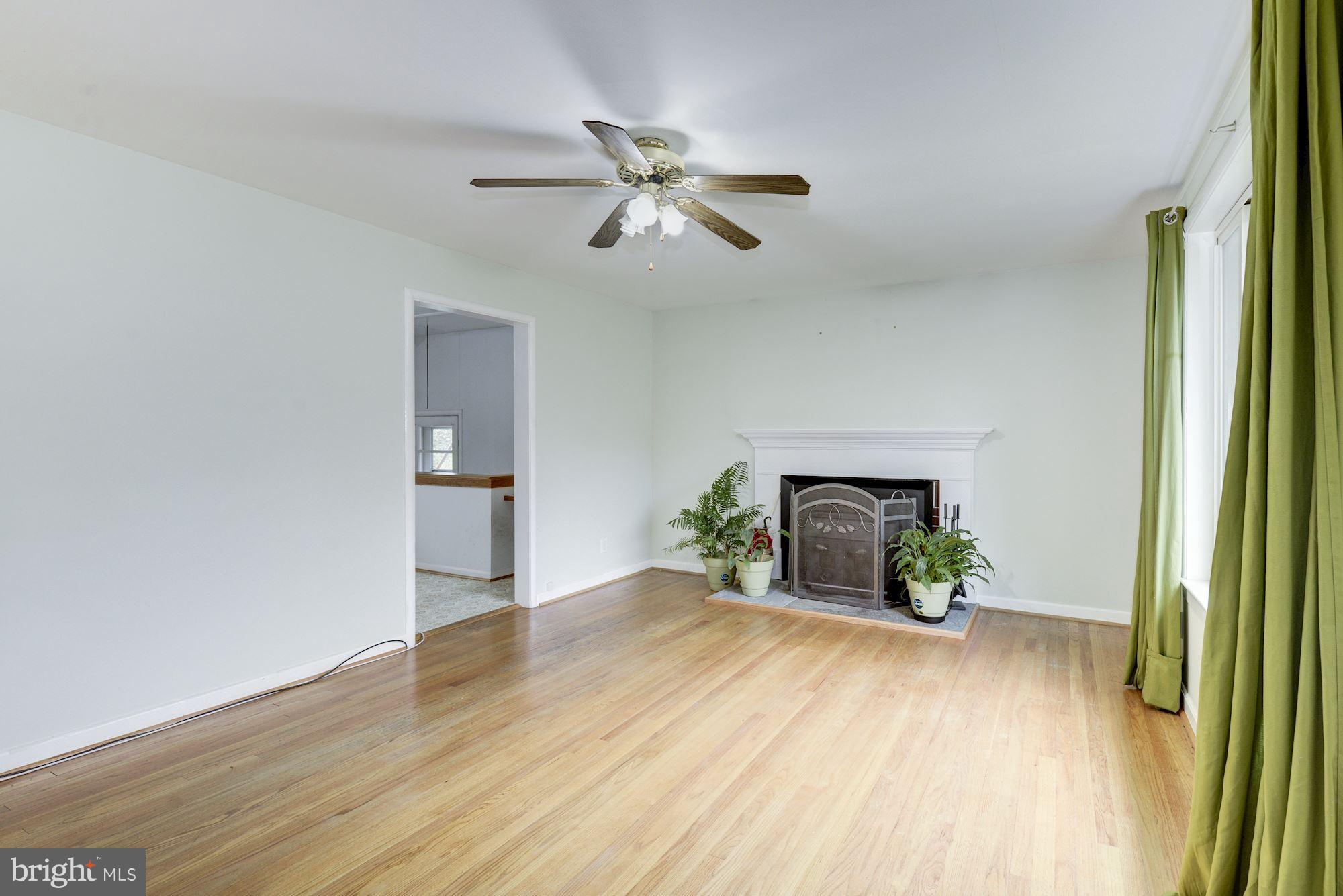 12510 Goodhill Road Silver Spring, MD 20906 - Photo 5 of 28 a view of empty room with wooden floor and fan