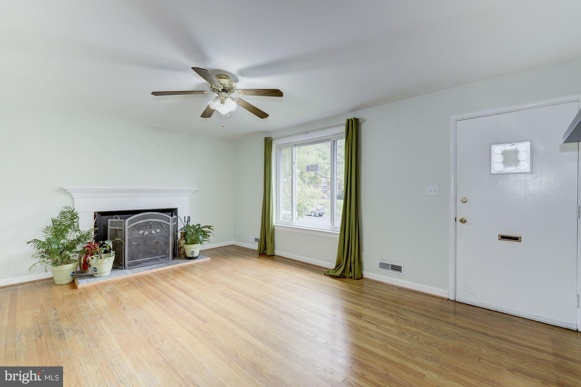 12510 Goodhill Road Silver Spring, MD 20906 - Photo 6 of 28 a view of a livingroom with a fireplace and window
