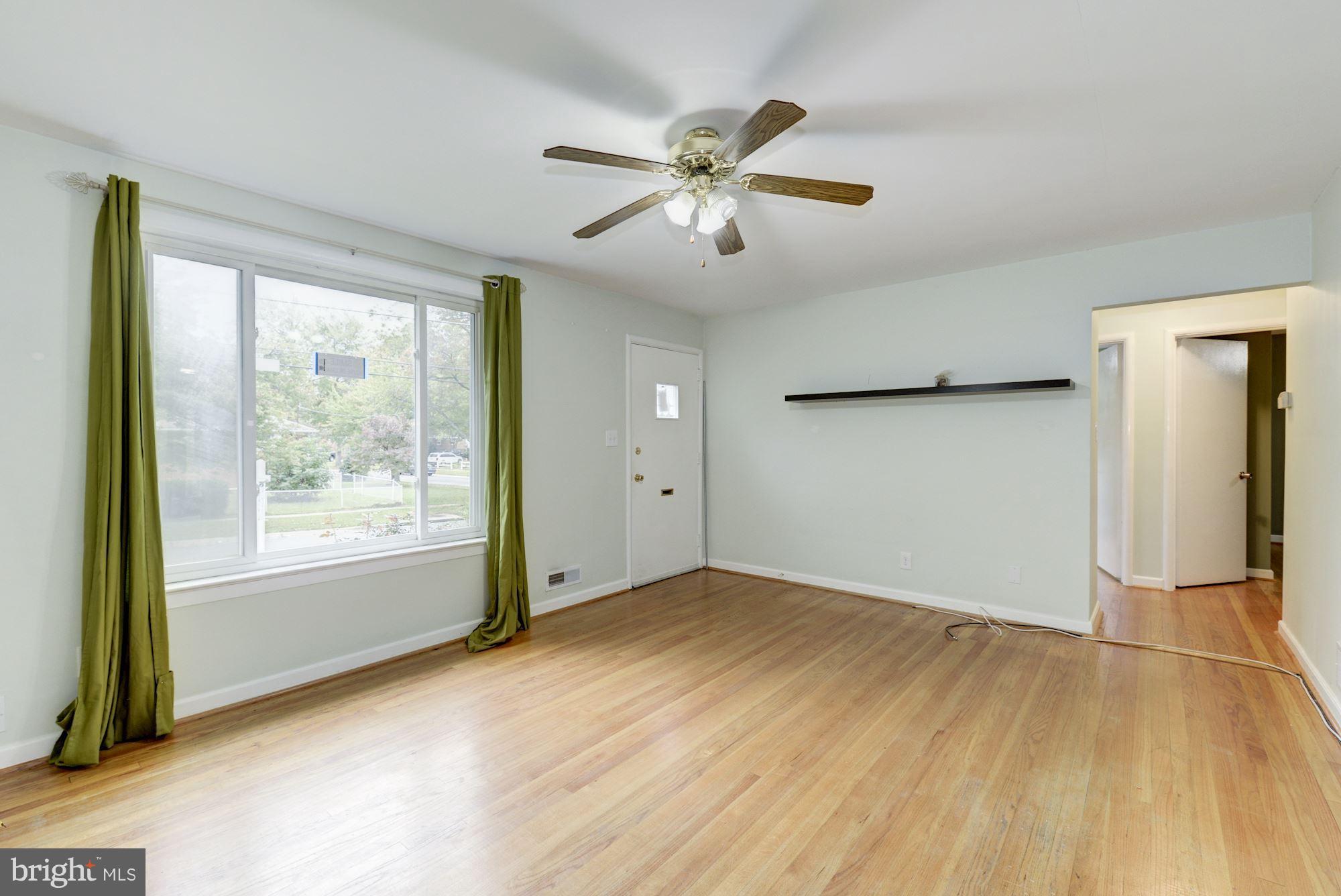 12510 Goodhill Road Silver Spring, MD 20906 - Photo 7 of 28 a view of an empty room with wooden floor and a window