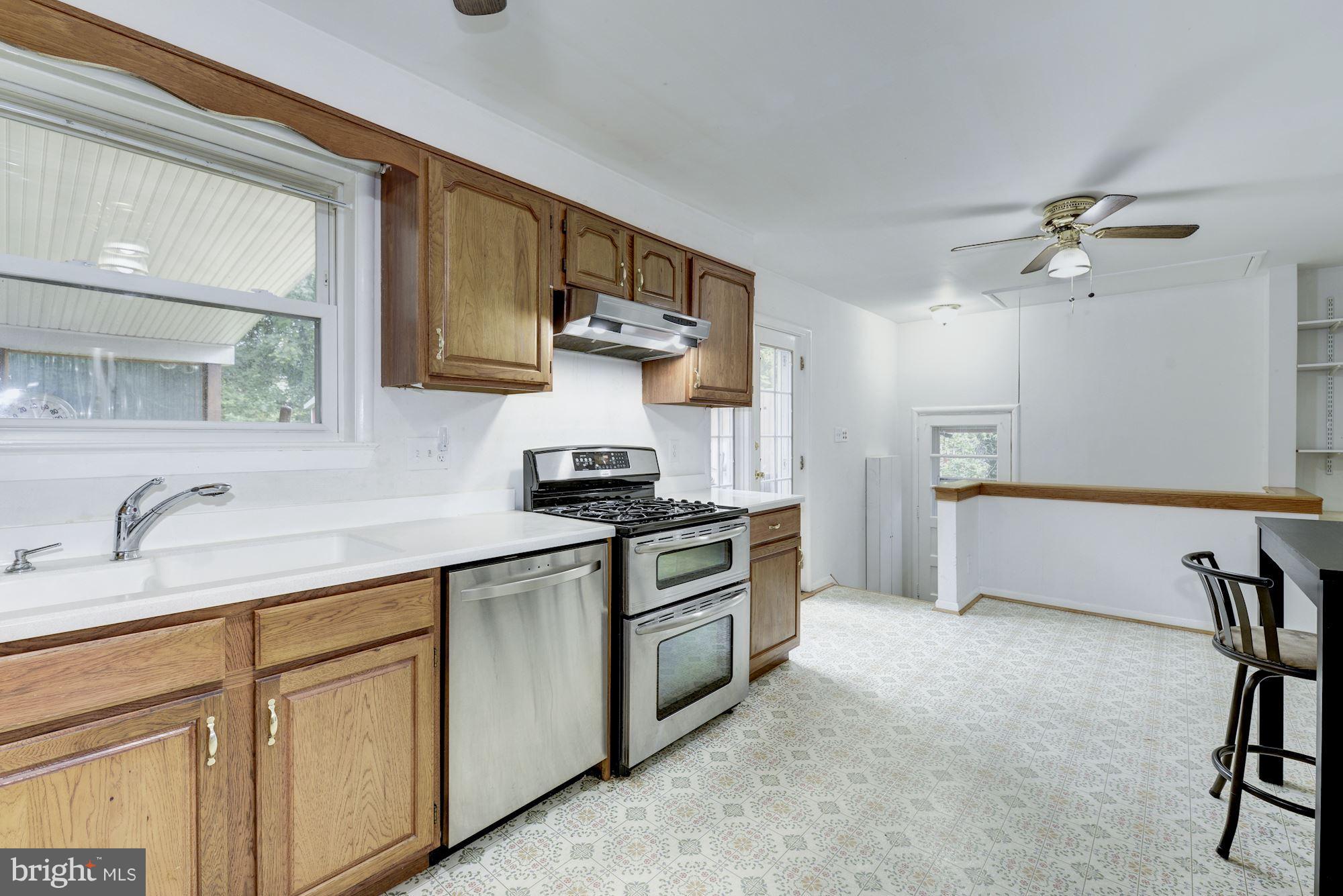 12510 Goodhill Road Silver Spring, MD 20906 - Photo 9 of 28 a kitchen with stainless steel appliances granite countertop a sink and cabinets