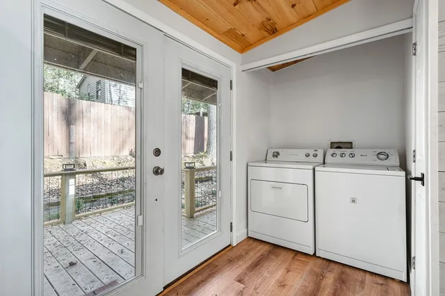 a utility room with cabinets washer and dryer