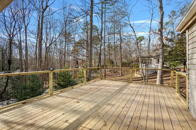 a view of a balcony with wooden floor and fence