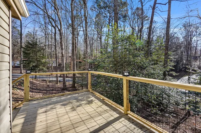 a view of a house with a yard and trees