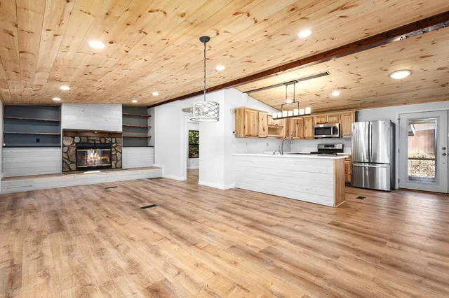 a view of kitchen with furniture and wooden floor