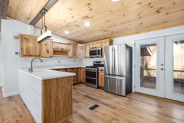 a kitchen with stainless steel appliances granite countertop a sink stove and refrigerator