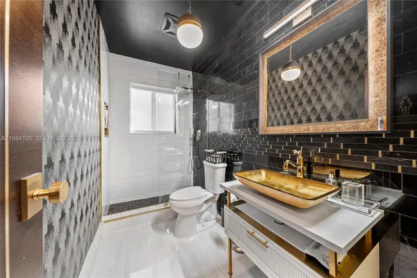 a bathroom with a sink a toilet and a mirror