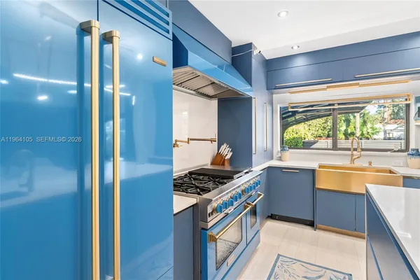 a kitchen with stainless steel appliances granite countertop a sink and a stove