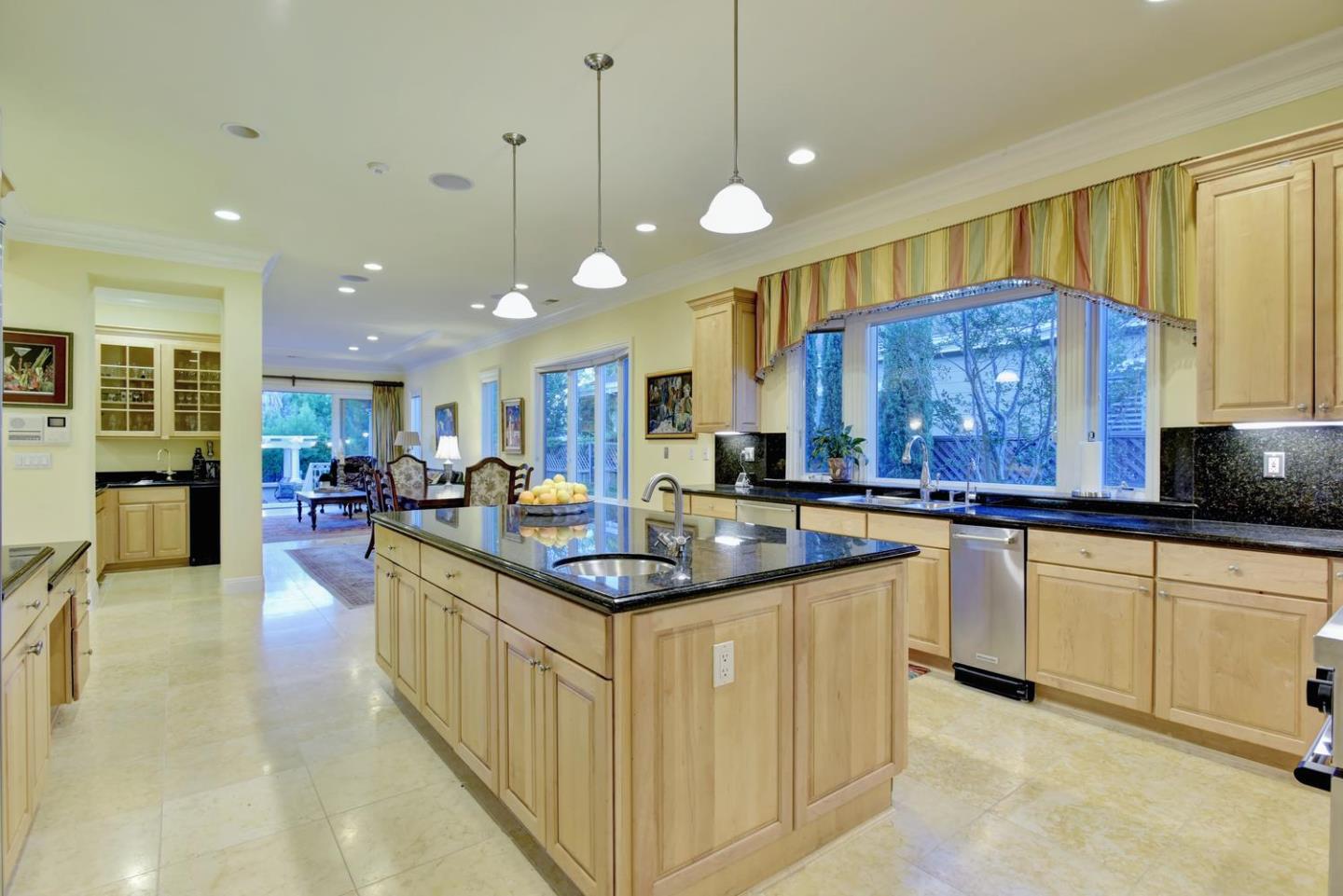15867 Mina Way Saratoga, CA 95070 - Photo 18 of 43 a kitchen with stainless steel appliances granite countertop a sink a stove and a wooden cabinets