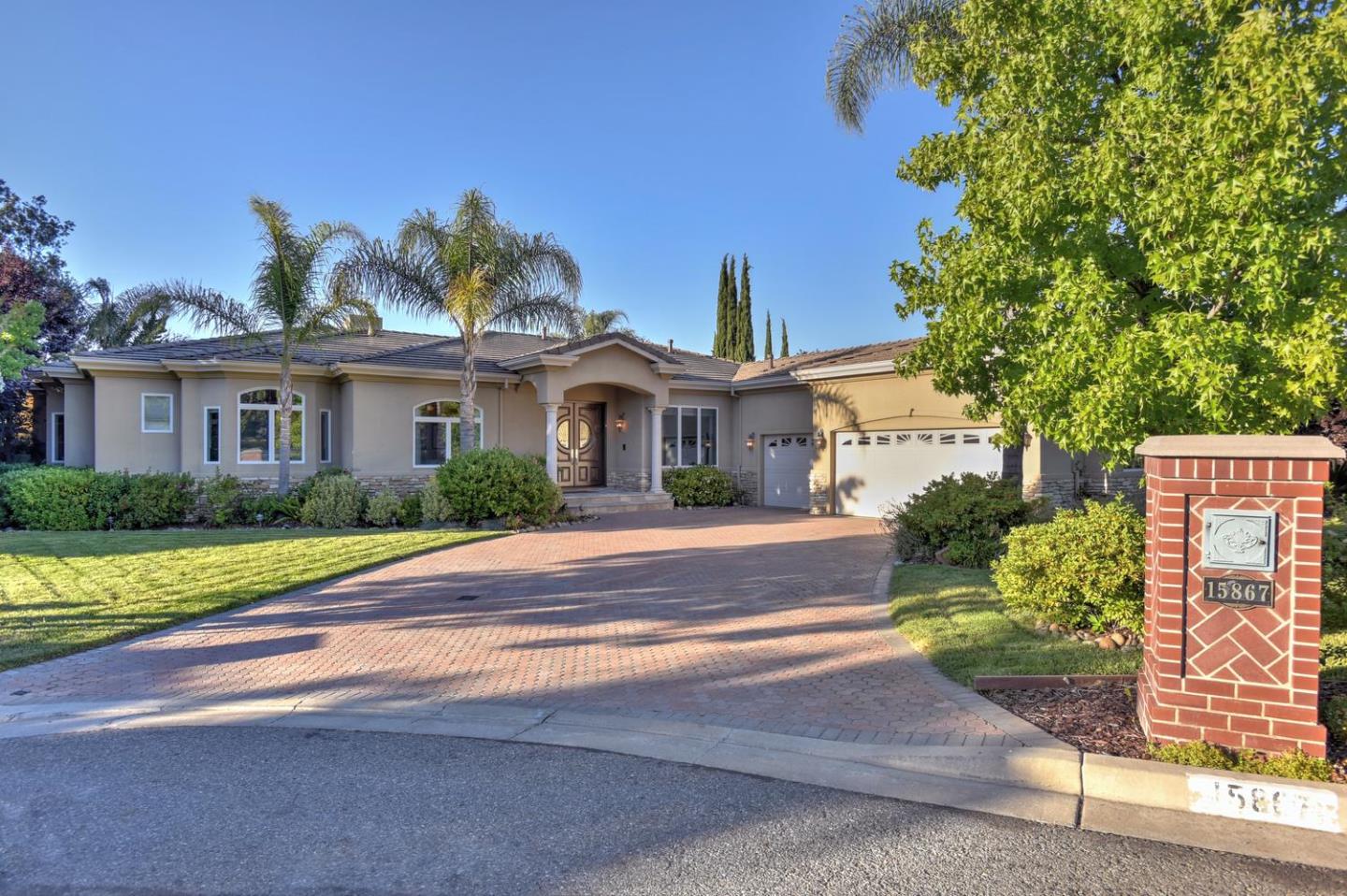 15867 Mina Way Saratoga, CA 95070 - Photo 2 of 43 a front view of a house with a yard and potted plants
