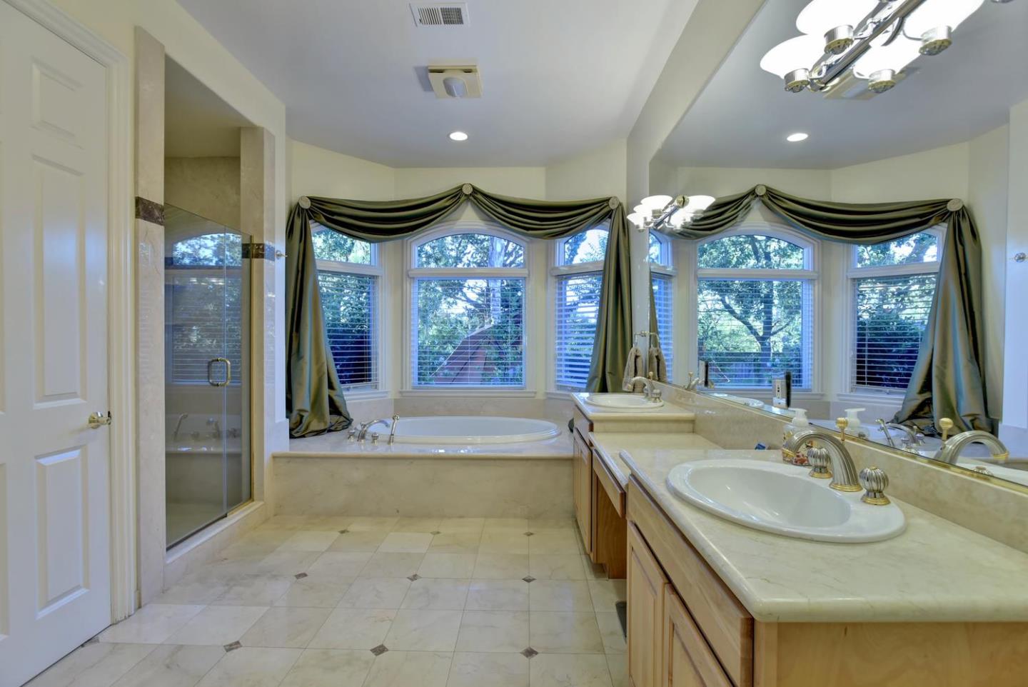 15867 Mina Way Saratoga, CA 95070 - Photo 21 of 43 a spacious bathroom with a sink a large mirror and a shower