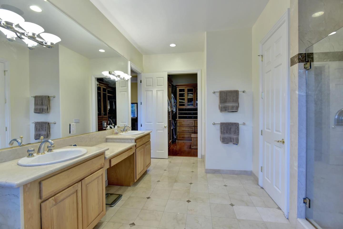 15867 Mina Way Saratoga, CA 95070 - Photo 22 of 43 a spacious bathroom with a shower a sink and a mirror