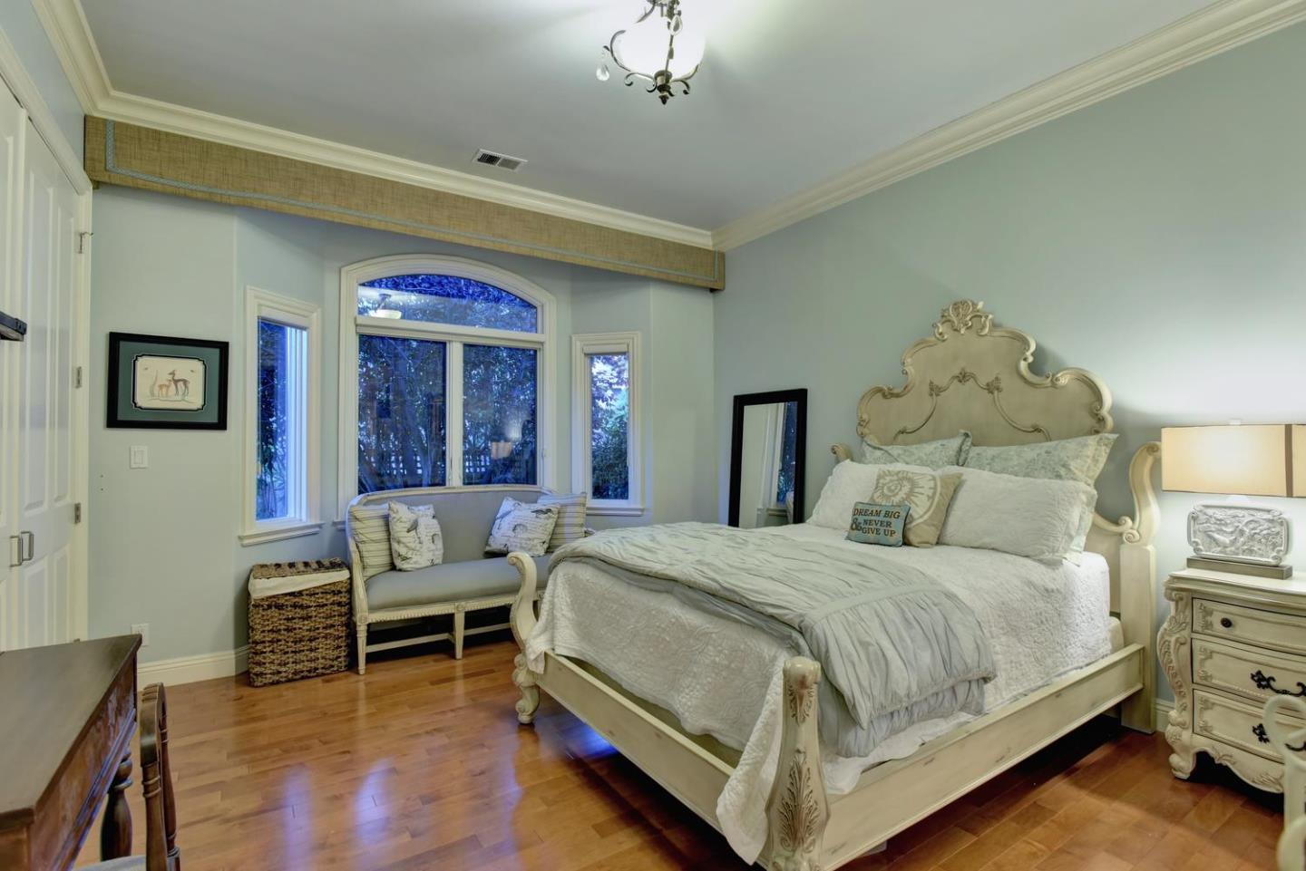 15867 Mina Way Saratoga, CA 95070 - Photo 25 of 43 a bedroom with a bed and a chandelier