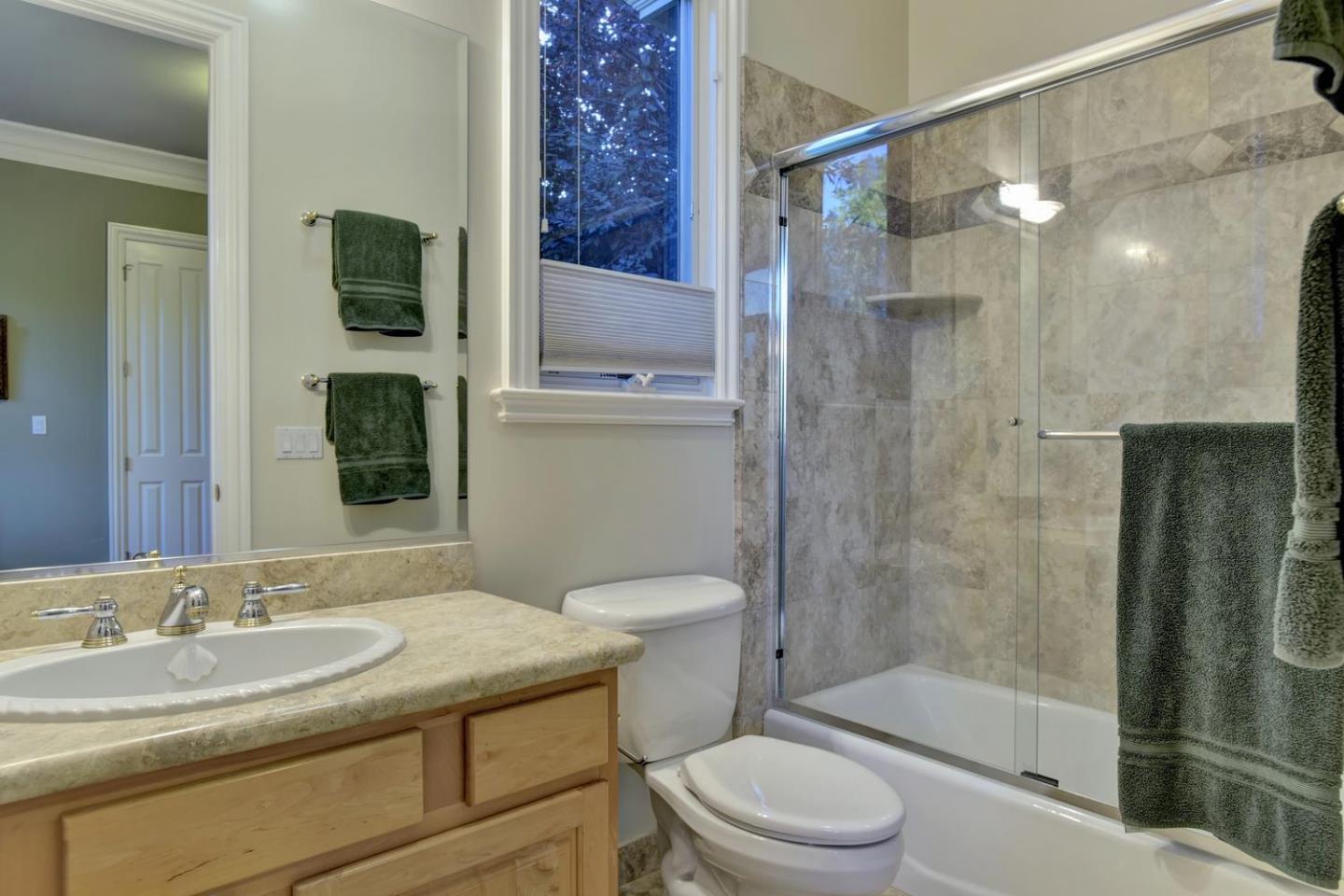 15867 Mina Way Saratoga, CA 95070 - Photo 28 of 43 a bathroom with a sink toilet and shower