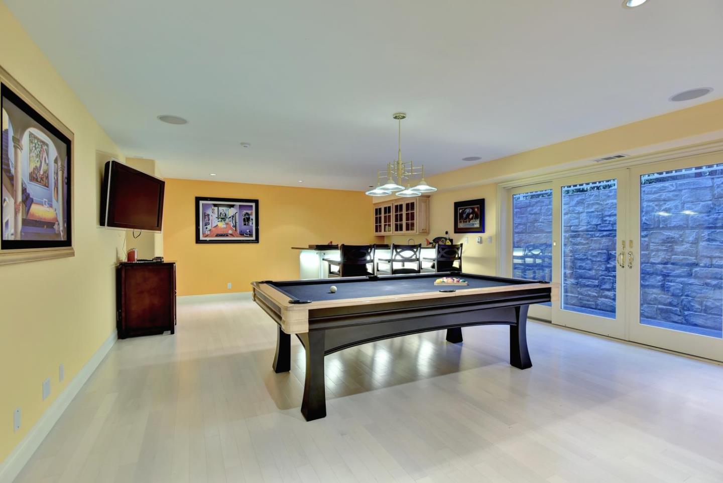 15867 Mina Way Saratoga, CA 95070 - Photo 29 of 43 a living room with furniture a table and a flat screen tv