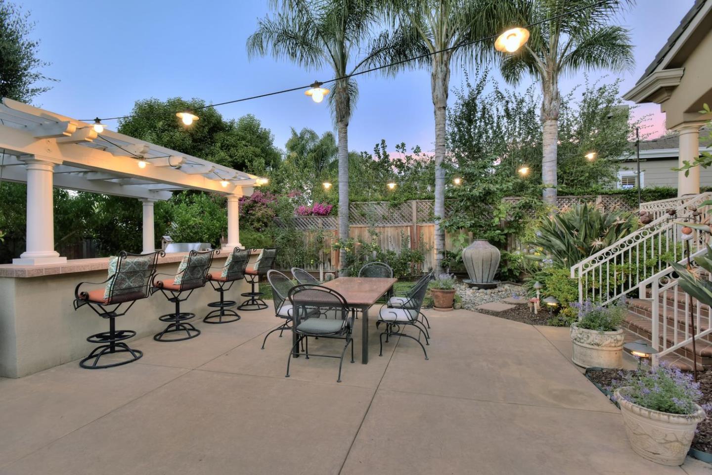 15867 Mina Way Saratoga, CA 95070 - Photo 37 of 43 a view of a patio with couches table and chairs and potted plants