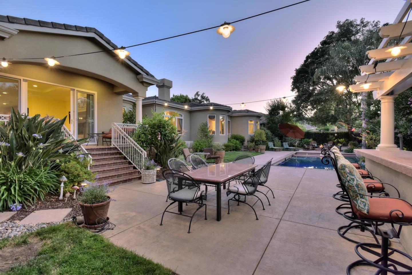 15867 Mina Way Saratoga, CA 95070 - Photo 38 of 43 a view of a patio with table and chairs potted plants and a large tree