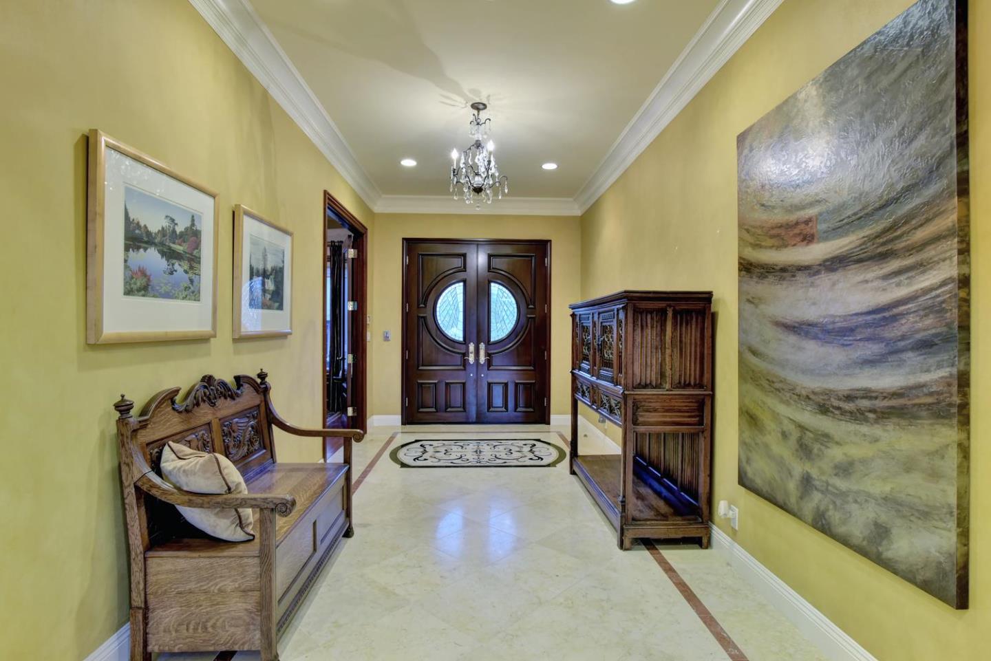 15867 Mina Way Saratoga, CA 95070 - Photo 5 of 43 a living room with furniture a chandelier and a fireplace
