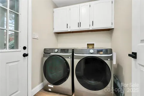 a view of a storage and utility room with washer and dryer