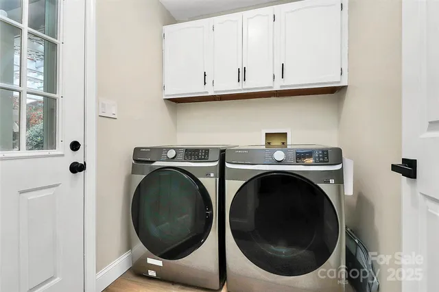 a view of a storage and utility room with washer and dryer