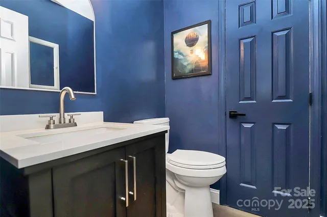 a bathroom with a toilet a sink and mirror