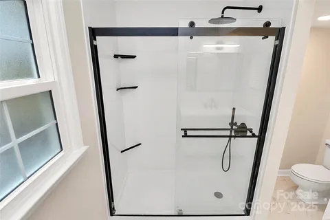 a bathroom with a glass shower door