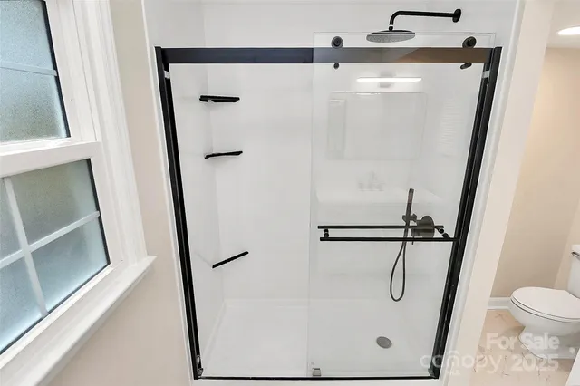 a bathroom with a glass shower door