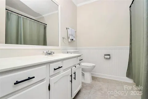a bathroom with a sink a toilet and mirror