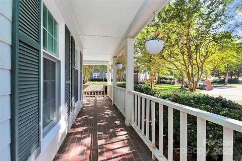 a view of a porch with wooden floor and fence