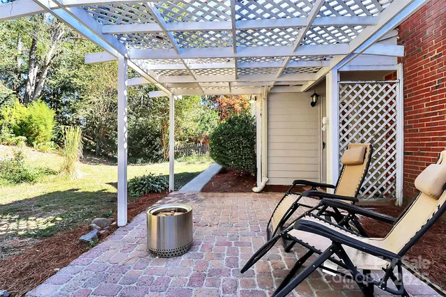 a view of a patio with table and chairs and potted plants