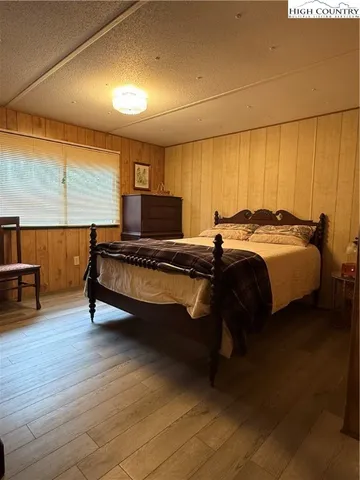a bedroom with a bed and large window