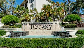 a view of sign board with large trees
