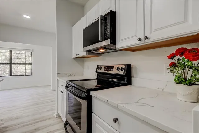 a bathroom with a sink vanity mirror and toilet