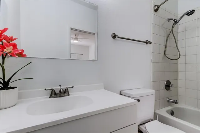 a living room with furniture a fireplace and a chandelier