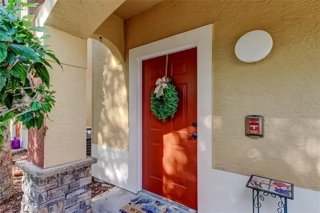 a kitchen with a refrigerator and countertop white cabinets