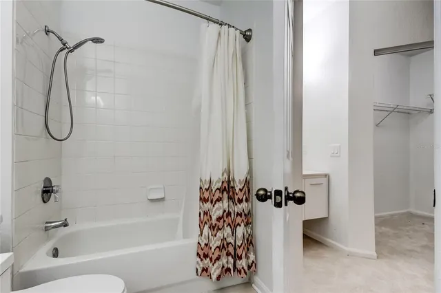 a room with furniture pool table and windows