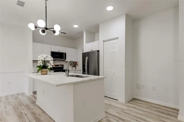a view of a kitchen with microwave and cabinets