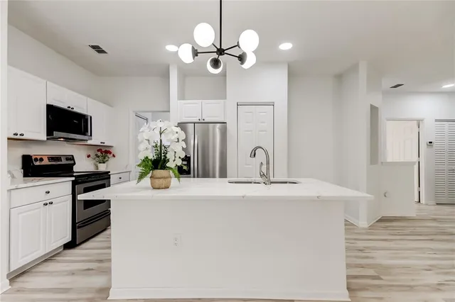 an empty room with a window and ceiling fan