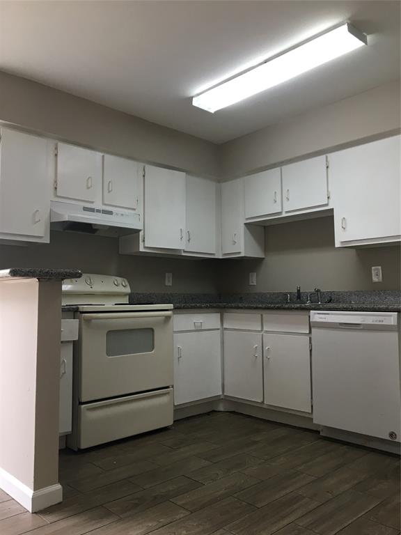 5625 Antoine Drive, Unit 1301 Houston, TX 77091 - Photo 1 of 15 a kitchen with granite countertop white cabinets and white appliances