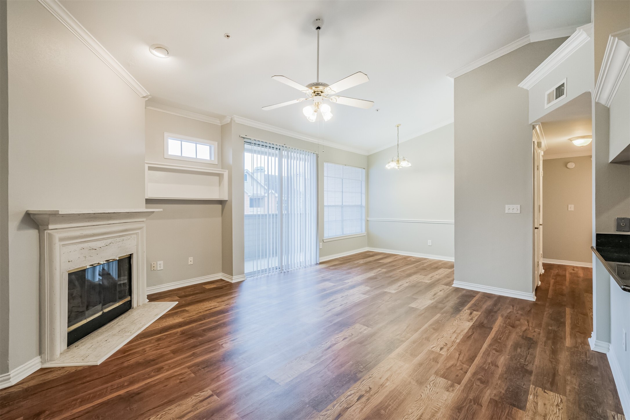 2111 Welch Street, Unit B304 Houston, TX 77019 - Photo 6 of 37 a view of an empty room with wooden floor fireplace and a window
