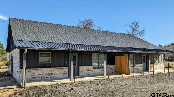 a porch with a table and chairs