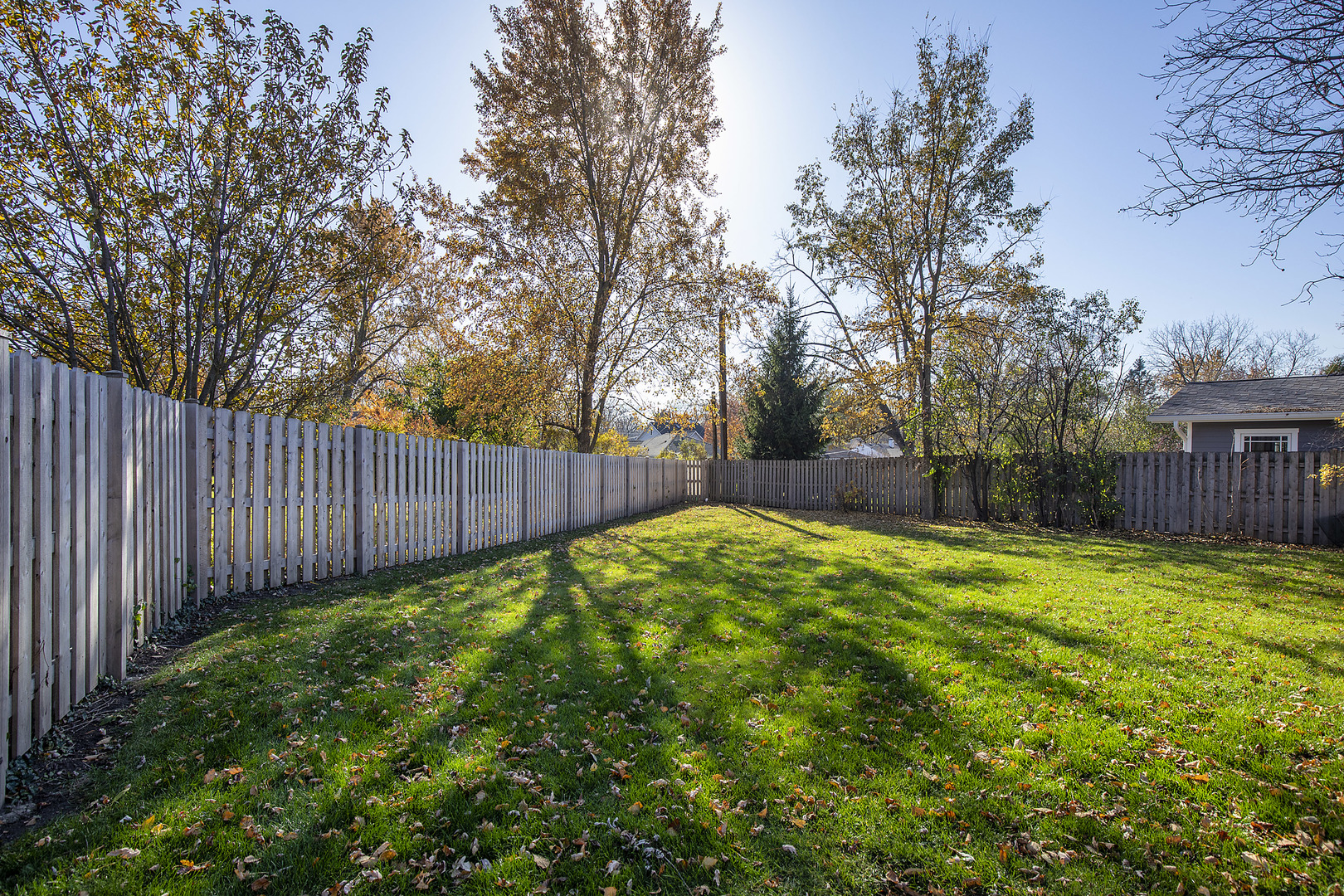 1913 Milton Avenue Northbrook, IL 60062 - Photo 14 of 24 a view of a backyard with wooden fence and large trees