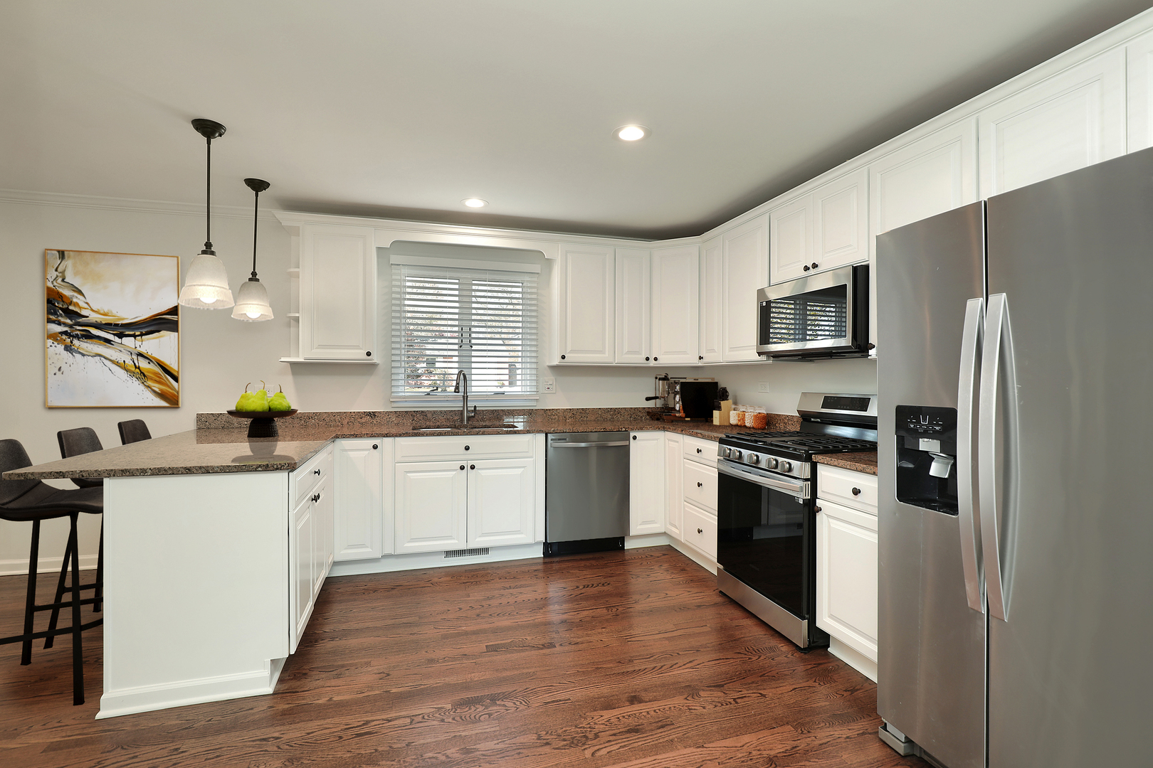 1913 Milton Avenue Northbrook, IL 60062 - Photo 6 of 24 a kitchen with stainless steel appliances granite countertop a refrigerator a sink dishwasher a stove and white cabinets with wooden floor