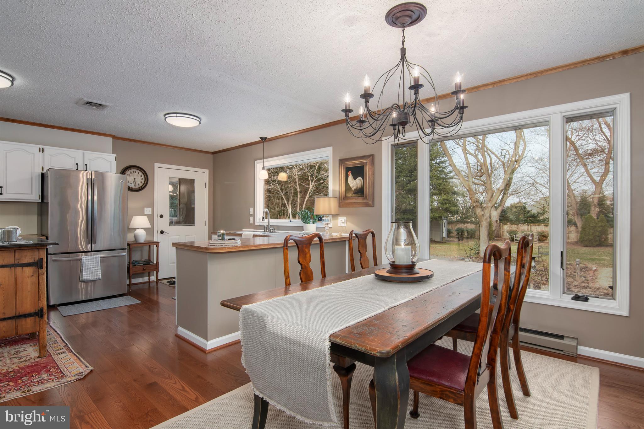 5529 Whitehall Road Cambridge, MD 21613 - Photo 24 of 41 a dining room with furniture a chandelier and window